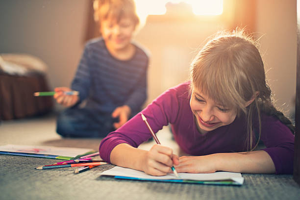 istock Sister and brother enjoying drawing together 474276202