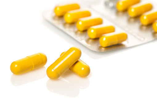 Yellow capsules  isolated on white background