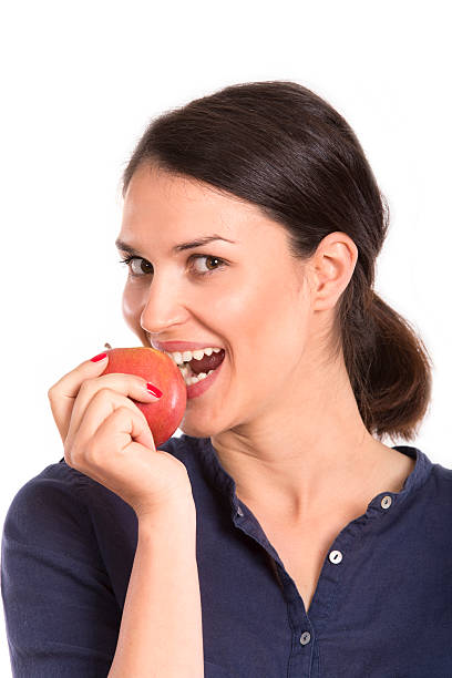 istock young woman eating apple 474280536
