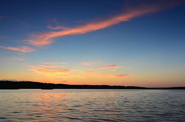 istock Small wooden pier on big lake at sunset 474283606