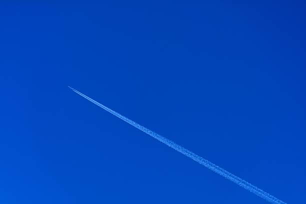 istock Vapor trail- A plane flying on a perfectly blue sky 474286142