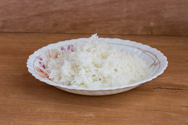 istock Bowl of Rice on wood background 474287292
