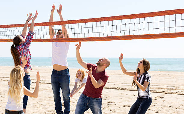 istock People play volleyball on beach 474287548