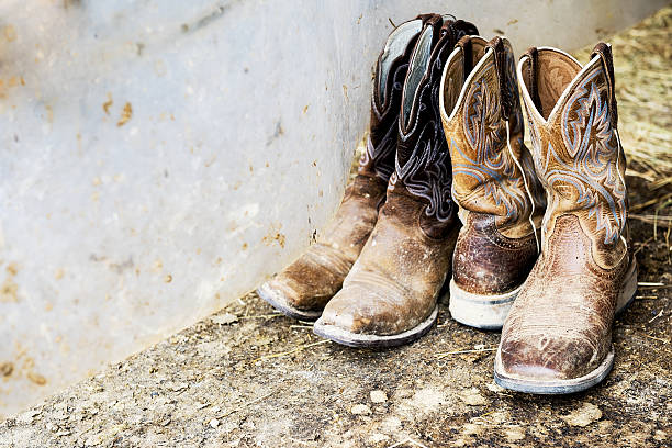 Cowboy footwear Two pairs of cowboy footwear belt leather isolated close up stock pictures, royalty-free photos & images