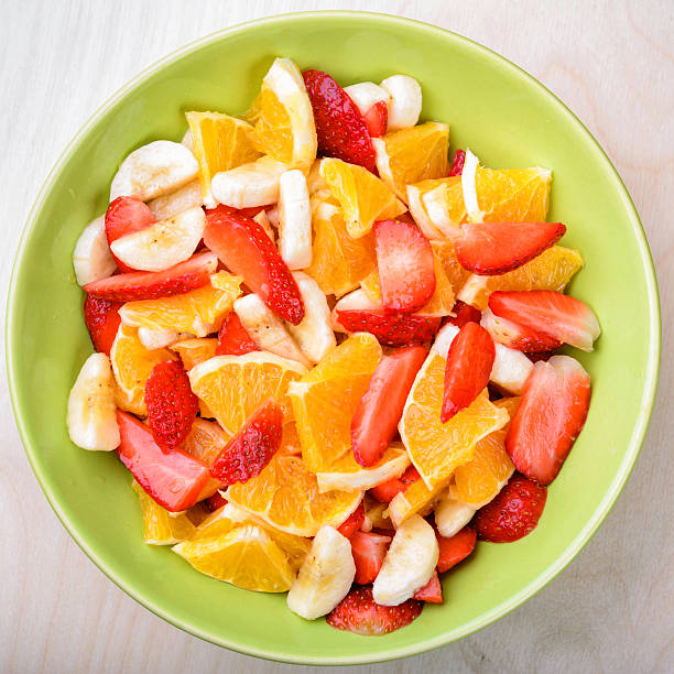 istock Fruit salad with strawberries, oranges and bananas 474292022