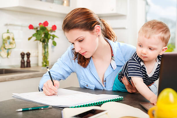 istock Young mother working with her baby 474295936