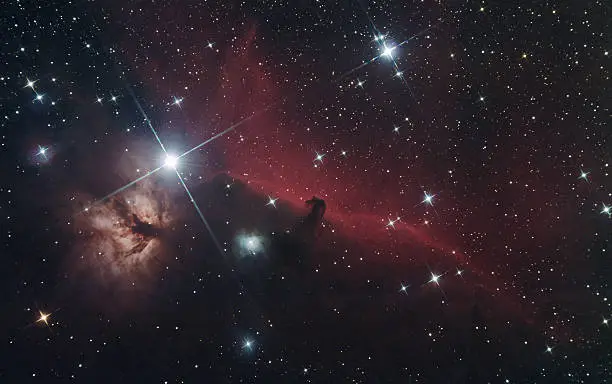 This is an image of the beautiful Horsehead and Flame Nebula in the constellation Orion.  The "horse's head" is 1500 light years distant and formed by a cloud of dust silhouetted against the nebula in the background.  The red nebula is formed by emitted ionized gas from the star Sigma Orionis.