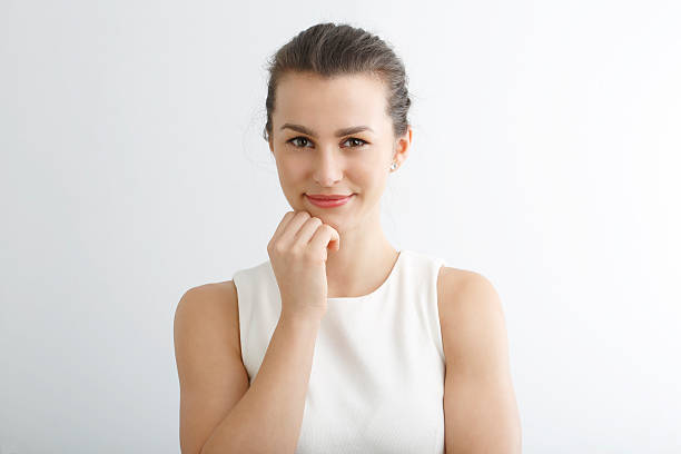 istock Beautiful young woman smiling against white background. 474297363