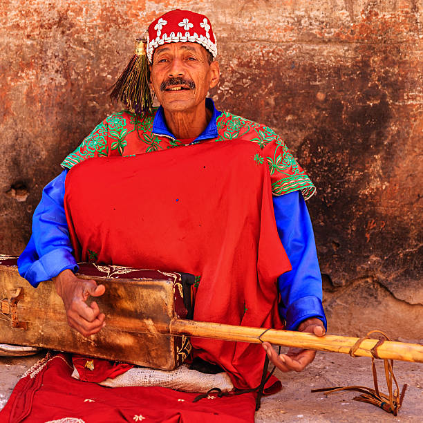 Street musician in Marrakesh, Morocco Moroccan street musician in traditional costume on Djemaa el Fna square, Marrakech, Morocco. Djemaa el Fna is a heart of Marrakesh's medina quarter.http://bem.2be.pl/IS/morocco_380.jpg djemma el fna square stock pictures, royalty-free photos & images