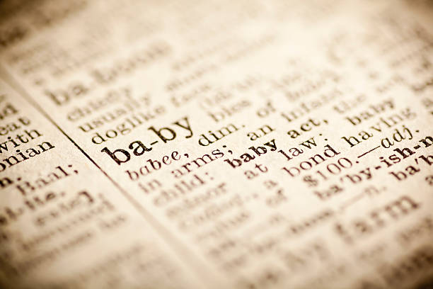 istock Old dictionary open on the word baby 474299460