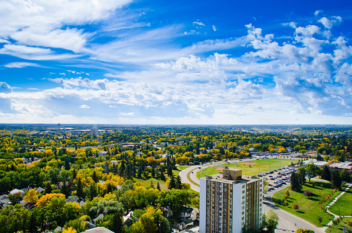 A view of south Edmonton from a tower in fall with the university of Alberta education centre in the corner. 