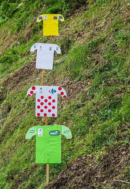 Decorations of Distinctive Jerseys of Le Tour de France 2014 Bagneres-de-Bigorre,France - 24 July 2014: Paper decoration of distinctive jerseys of Le Tour de France are on a green slope on the roadside to Col de Tourmalet during the stage 18 of Le Tour de France on 24 July 2014 in Bagneres de Bigorre. cycling vest photos stock pictures, royalty-free photos & images