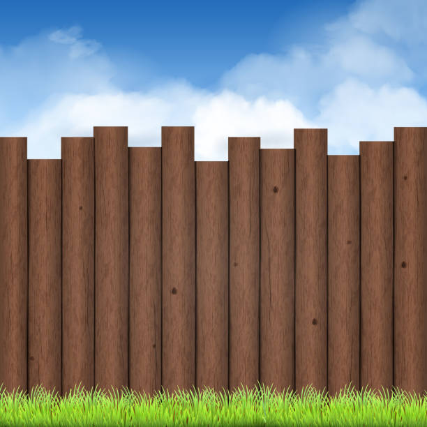 istock wooden fence with green grass and blue sky 474309120
