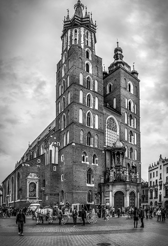 Cracow ( Krakow ), Poland - May 01, 2015: black and white photo of Mariacki church at the Main Square in Cracow ( Krakow ), Poland