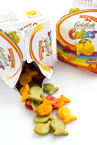 Miami, florida, USA - September 27, 2014: two 2 oz (57grams) packages of Pepperidge Farm Goldfish baked snack crackers on white background. Pepperidge Farm is a commercial bakery in the U.S. founded in 1937 by Margaret Rudkin, who named the brand after her family's property in Fairfield, Connecticut, which in turn was named for the pepperidge tree, Nyssa sylvatica. It is based in Norwalk, Connecticut. In 1961, it was acquired by Campbell Soup Company.