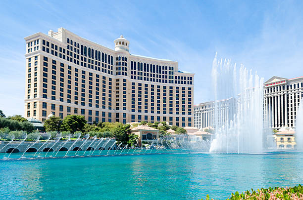 Fountains of the Bellagio Hotel, Las Vegas Las Vegas, Nevada - April 11, 2015: The famous fountains in action at the Bellagio Resort and Casino in Las Vegas, Nevada on a mildly cloudy. These large dancing water fountains are synchronized to music and play on the half hour both during the day and at night.  bellagio stock pictures, royalty-free photos & images