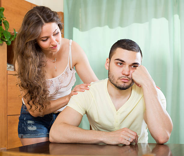 istock Woman concoling depressed man 474312360