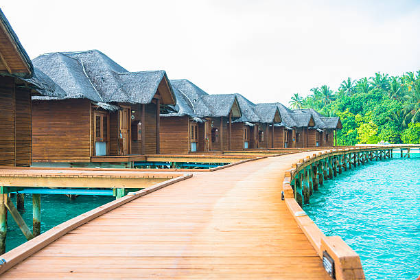 istock Over water bungalows with steps into amazing green lagoon 474313124