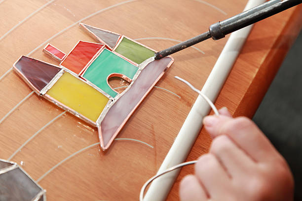 istock Stained glass maker at work on colorful castle 474316405