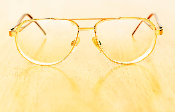 istock Vintage eye glasses on wooden table 474317194