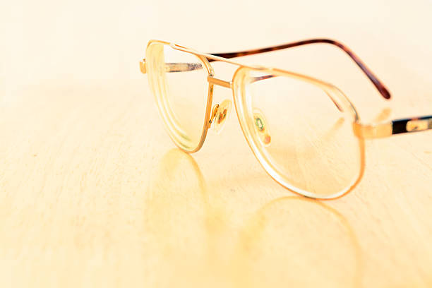 istock Vintage eye glasses on wooden table 474317198