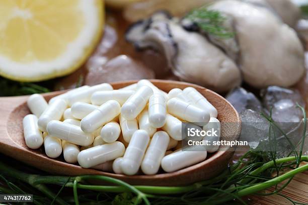 The Zinc Supplementary White Capsule With Fresh Oyster On Block Stock Photo - Download Image Now