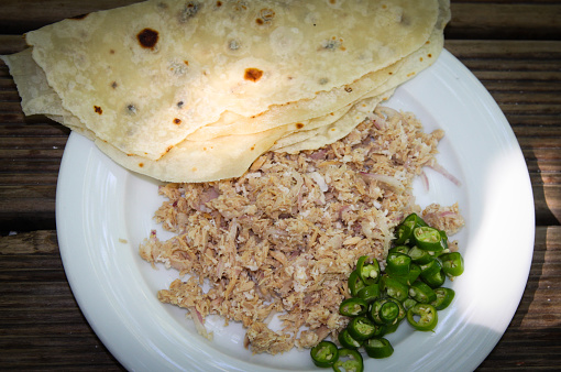 Traditional Maldivian Mashuni Food, consisting of Tuna Fish, Coconut, Green Chillie, Onion, Garlic and lime juice. It is served with Roshi, a flat thin bread similar to Indian Chapati