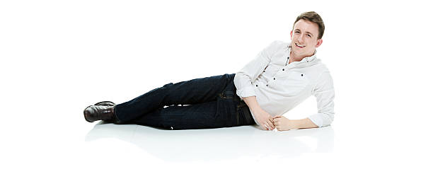 istock Smiling casual man lying on floor 474320642