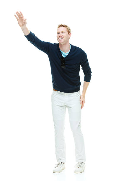 istock Smiling casual man waving hand and walking 474320656
