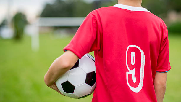 istock Child Holding a Soccer Ball 474320824