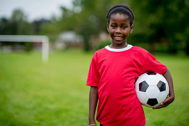 istock Girl Standing with Soccer Ball 474320830