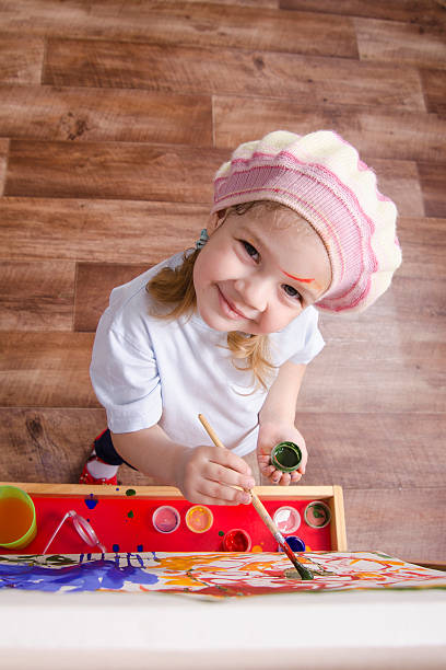 istock Girl artist paints on canvas 474322639