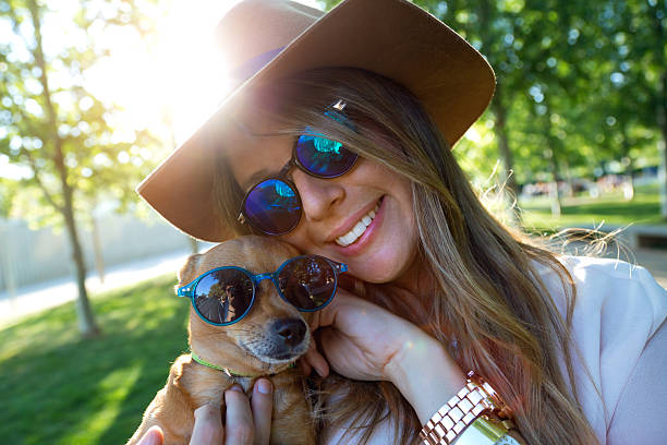 istock Beautiful young woman looking at camera with her dog. 474324804