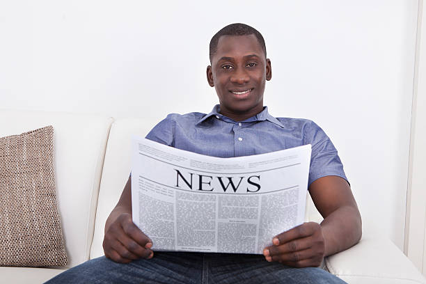 istock African Man Holding Newspaper 474324856