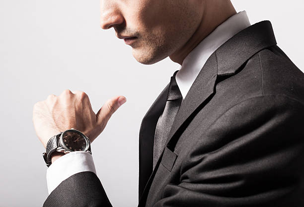 istock Man checking the time on his wrist watch 474325490