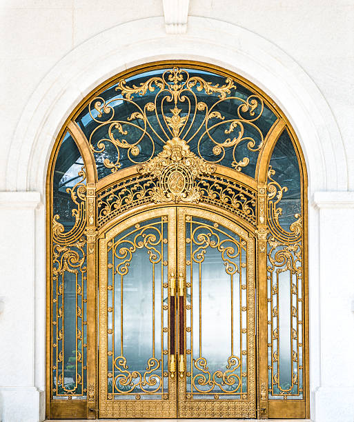 istock Closed door of building with gold ornate pattern. 474327315