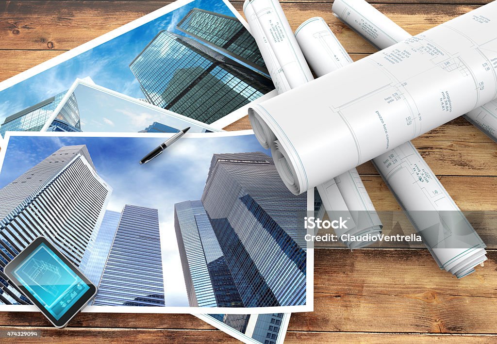 blueprints and pictures of skyscrapers blueprints and pictures of skyscrapers on wooden background 2015 Stock Photo