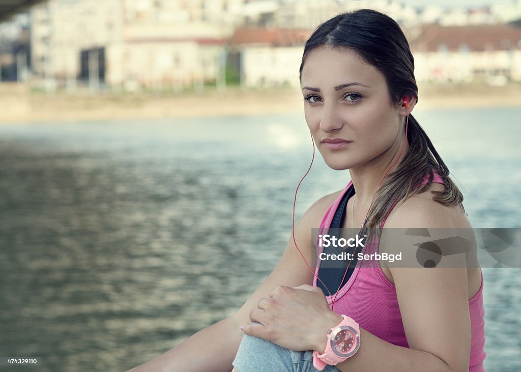 Sport woman having a break Woman having a break from running by the river. 2015 Stock Photo