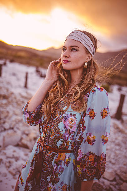 istock Boho girl in a summer evening landscape with clouds 474331618