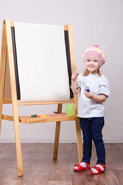 istock Girl artist paints on canvas 474332635