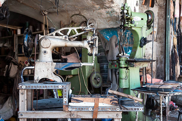 Aleppo, Syria - June 25, 2010: And old Singer sowing machine at a shoe repair shop located on a downtown sidewalk in Aleppo, Syria