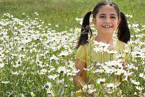 istock Girl Surrounded By Flower Plants In Meadow 474333537