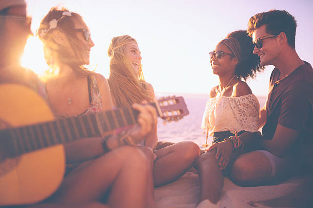 istock Friends at a sunset beachparty with a guitar 474333732