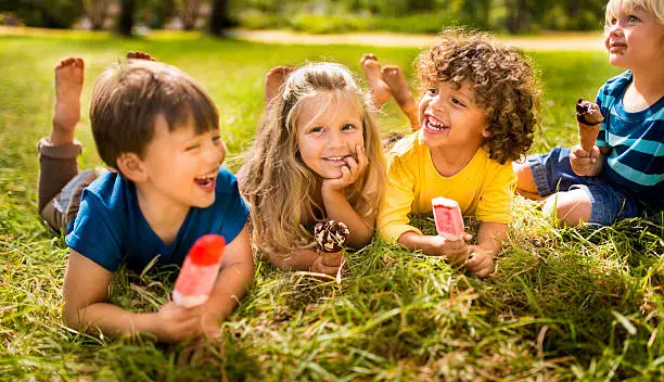 Photo of Children friends eating ice creams in park