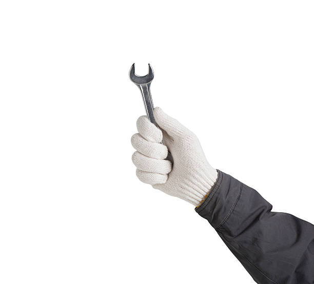 istock Working hand in glove holding wrench 474333892