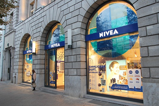 Berlin, Germany - August 26, 2014: Person exits Nivea store in Unter den Linden, Berlin. Nivea is a brand of Beiersdorf, German personal care company. It dates back to 1882.