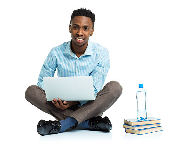 istock Happy african american college student with laptop on white 474334858