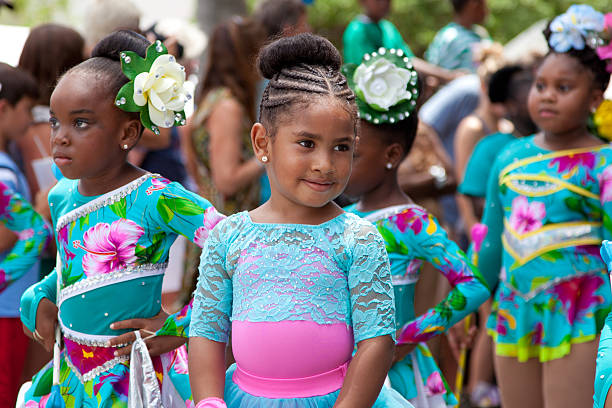 children dancers at a parade during St. John Carnival, USVI St. John, US Virgin Islands - July 4, 2013: children troupes during a month-long St. John Festival and Carnival, the theme for 2013's Festival was "Come and Explore the Culture Scene for Festival 2013" virgin islands photos stock pictures, royalty-free photos & images