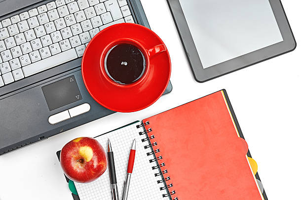 istock Laptop and office supplies on white 474337087