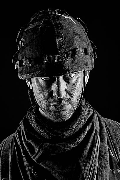 US marine half-turned to the camera. His brother-soldier looking forward to the camera